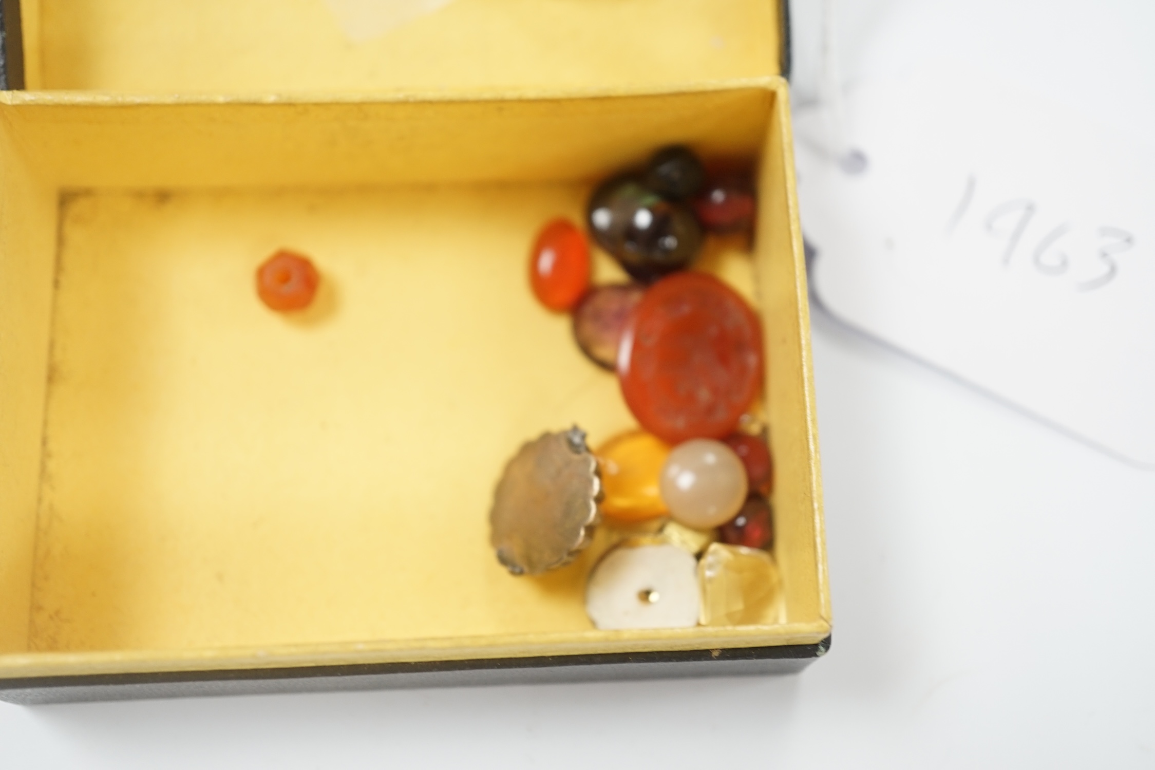 A small quantity of loose cut and cabochon gemstones including carnelian, white opal etc.